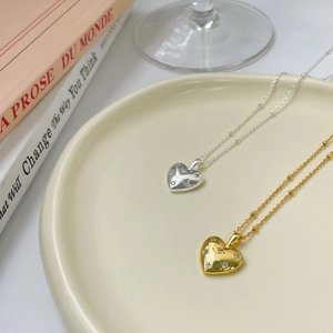 Minimalist S925 sterling silver heart necklace with star-set cubic zirconia in gold and silver