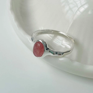Macro detail of oval pink strawberry crystal on S925 sterling silver hammered ring band