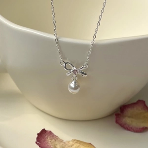 Elegant S925 silver necklace with a pink crystal bow and a white shell pearl pendant