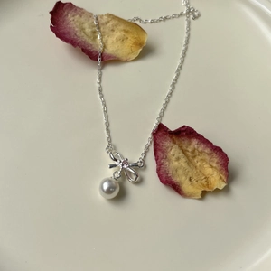 S925 sterling silver bow necklace with a pink zircon and white pearl pendant