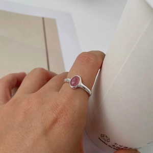 Elegant 925 sterling silver ring featuring an oval pink strawberry crystal on model hand