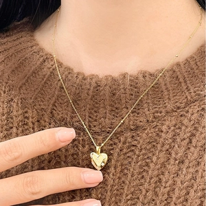 Elegant gold heart pendant necklace with zircon stones on a stylish bead chain