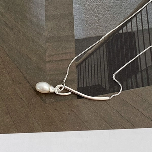 Macro view of S925 sterling silver stamp on the minimalist pearl drop necklace