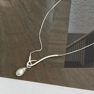 925 silver necklace with teardrop pearl pendant on modern minimalist magazine background