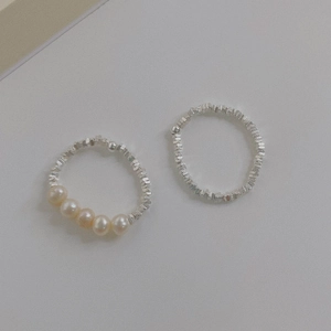 Minimalist S925 silver irregular fragment ring set with cream pearls on grey background
