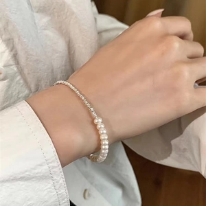 Detailed view of handmade silver nuggets and natural freshwater pearl bracelet on wrist