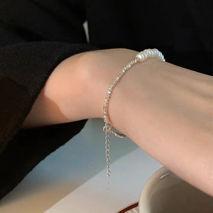 Detailed shot of 925 silver irregular beads and freshwater pearls bracelet on wrist