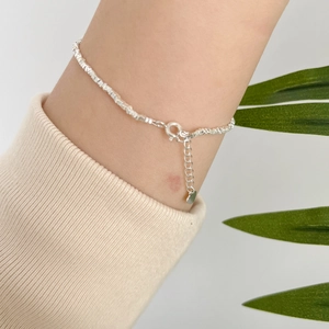 Detailed close-up of 925 silver beaded bracelet with heart charm and fresh water pearl