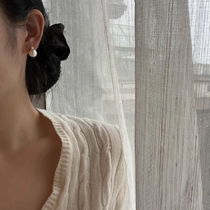 Minimalist pearl stud earrings with zircon inlay worn for a stylish lifestyle look