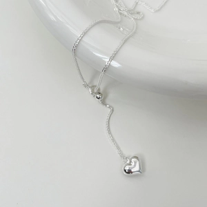 Detail of S925 sterling silver heart necklace showing the adjustable slider and shiny pendant
