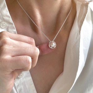 Minimalist 925 sterling silver necklace with irregular hollow pearl pendant on a model