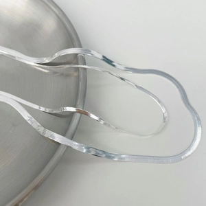Detail of S925 sterling silver snake chain necklaces with polished mirror finish on a tray