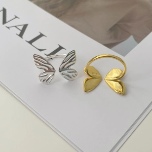 Close-up of S925 sterling silver butterfly rings in gold and silver finishes