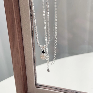 Elegant S925 silver necklace with a round white pearl and black zircon stone pendant