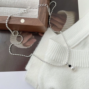 Close-up of S925 silver beaded chain with black zircon and white freshwater pearl pendant