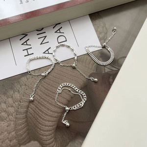 Detailed macro view of S925 sterling silver chain rings with adjustable bead clasps
