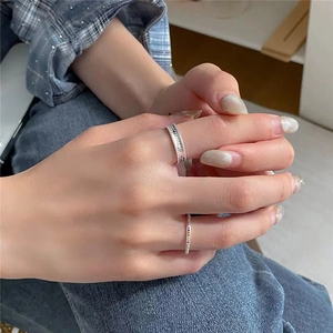 Detailed view of silver rainbow ring with multi-color stones and geometric textured band