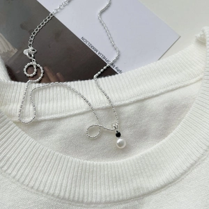 Detail of S925 silver beaded chain with black cubic zirconia and fresh water pearl pendant