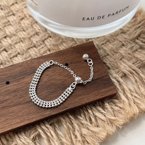 Detailed macro of S925 sterling silver double-layer woven chain ring with adjustable clasp