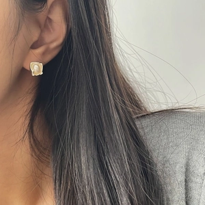 Detail of square silver pearl earring on ear, minimalist aesthetic jewelry accessory