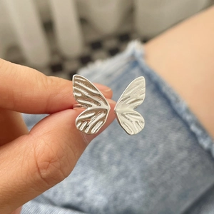 Detailed view of an S925 sterling silver butterfly ring with engraved wing textures