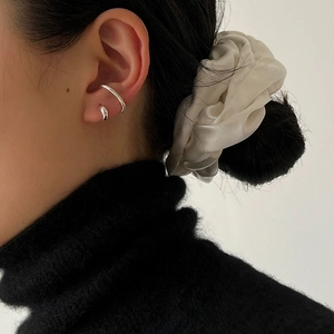 Close-up of S925 sterling silver double-layered ear cuff worn with a white silk scrunchie