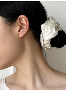 Detail of elegant S925 sterling silver double-line ear cuff and stud on model's ear