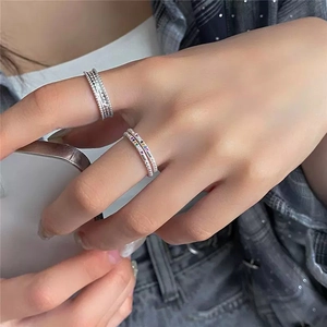 Detail of stacked S925 silver rings featuring colorful gemstones and hollow dot textures
