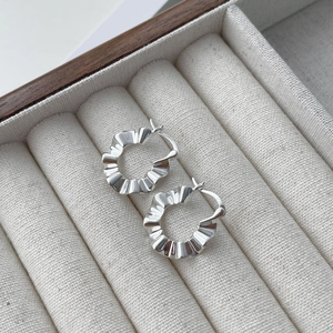 Minimalist S925 sterling silver hoop earrings with textured crinkle design on jewelry tray