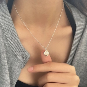 Minimalist sterling silver necklace with a diamond-shaped pendant and white pearl inlay