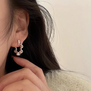 Detail view of stylish S925 sterling silver earrings with unique pleated wavy textures