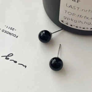 Detailed close-up of smooth black agate bead earrings with S925 sterling silver pins