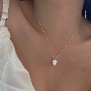 Elegant S925 silver heart necklace with starburst detail on model's neckline