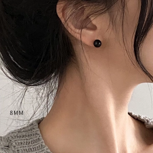 Minimalist 8mm black onyx stud earrings in S925 sterling silver worn by a model