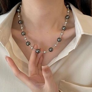 Gradient Tahitian style grey pearl necklace with silver beads on a female model