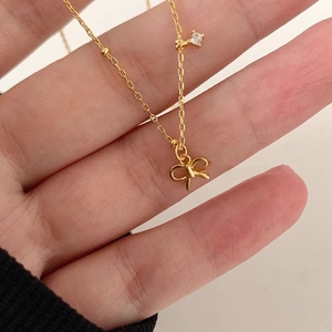 Elegant gold bow pendant necklace in S925 sterling silver with cubic zirconia accent
