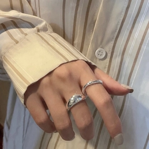 Minimalist irregular 925 silver rings stacked on fingers for a modern aesthetic look