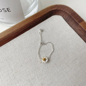 Detailed macro view of S925 sterling silver daisy ring with adjustable sliding bead chain