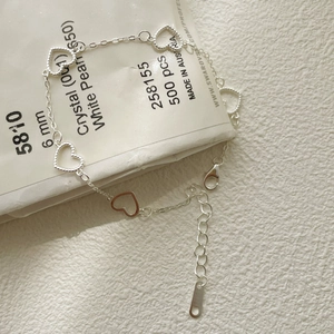 Macro shot of 925 sterling silver heart-shaped bracelet with lobster clasp and links