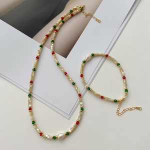 Detail of beaded necklace with Baroque pearl, mop tiles and vintage metal accents