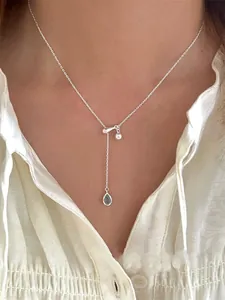 Close-up of S925 silver Y-shaped necklace with a blue waterdrop zircon pendant on a model