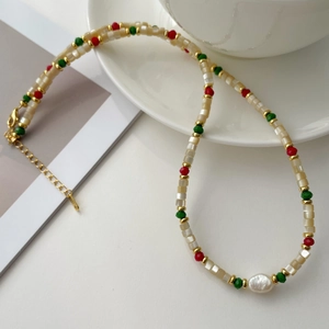 Detailed macro view of handmade beaded necklace with baroque pearl and lobster clasp