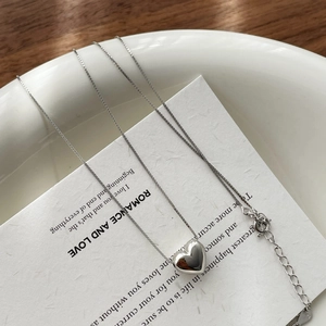 Close-up of S925 sterling silver heart pendant necklace with hallmark and box chain