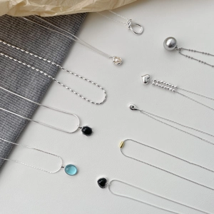S925 sterling silver necklaces featuring heart, black agate, and blue gemstone pendants