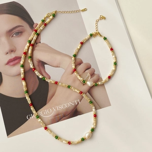 Detail of beaded necklace and bracelet set featuring baroque pearls and colorful beads