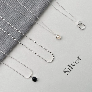 Detailed close-up of S925 sterling silver necklaces with heart and gemstone pendants