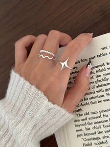 Minimalist S925 sterling silver star ring set styled on model with a cozy knit sweater