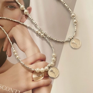 Close-up of S925 silver irregular beads and pearl necklaces with a floral pendant