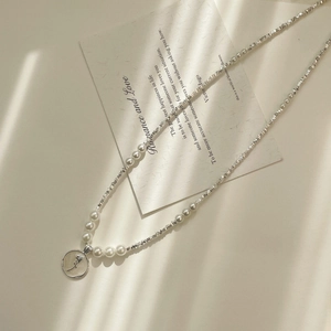 Detail of S925 silver pearl necklace featuring a white rose relief pendant and elegant pearls