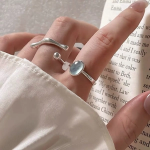 Minimalist S925 sterling silver ring set with oval aquamarine stone on model hand